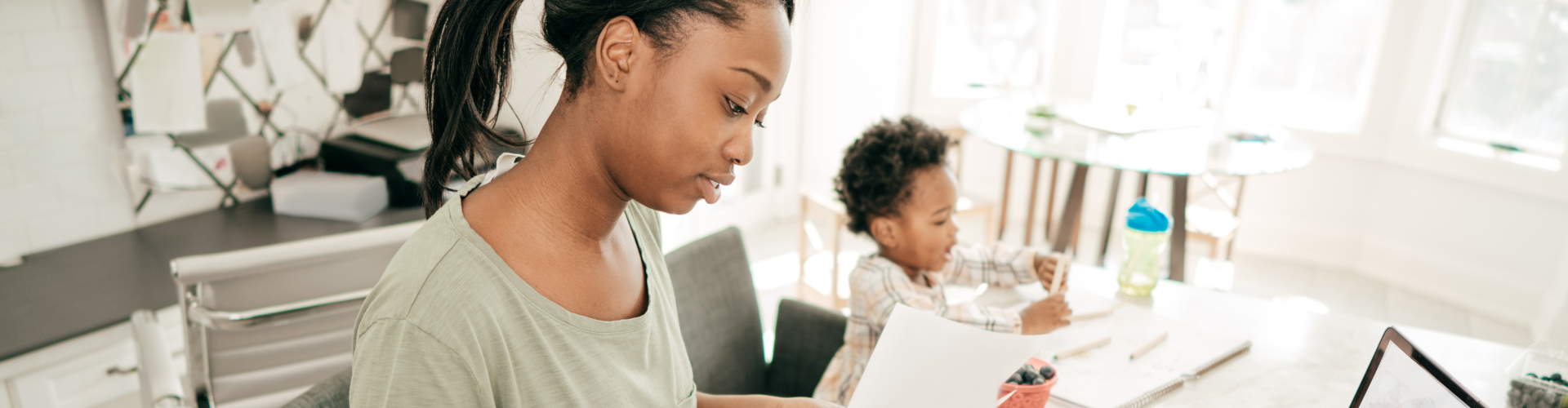 Woman with her child looking for a job results on a computer